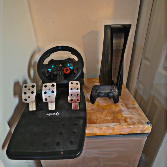 Ps5,with black controller and gaming wheel and game for the gaming wheel